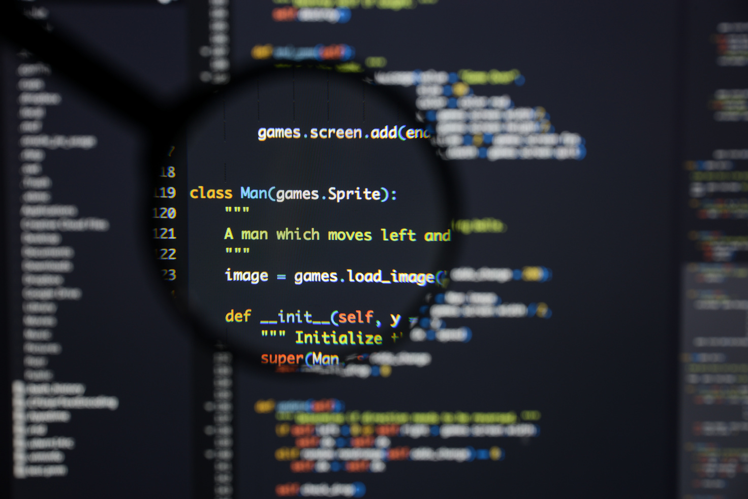 Real Python code developing screen. Programing workflow abstract algorithm concept. Lines of Python code visible under magnifying lens.